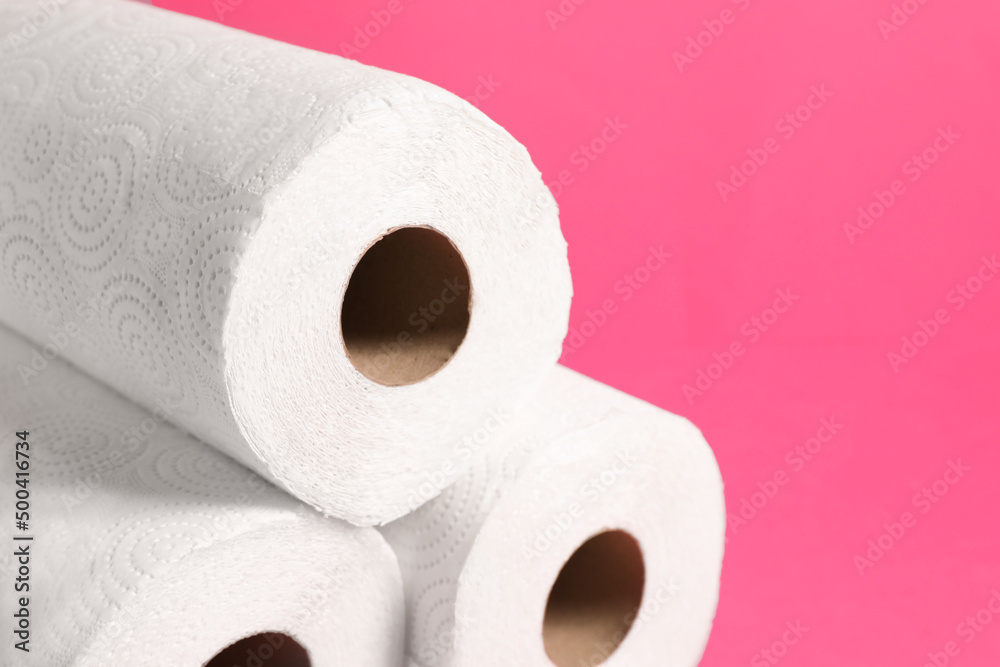 Many rolls of paper towels on pink background, closeup. Space for text Many rolls of paper towels on pink background, closeup. Space for text