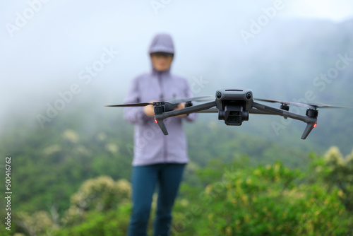 Flying drone in spring forest