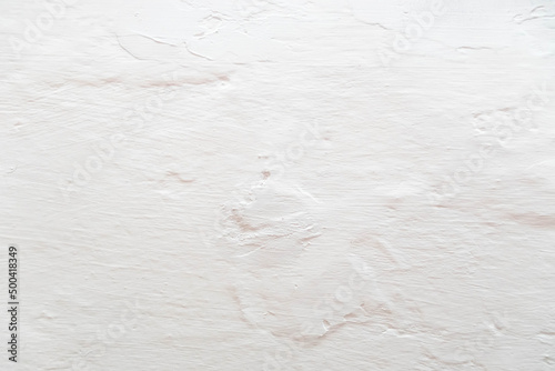 The background is in the form of gray rough plaster on the wall, whitewashed with chalk. Plaster tecture close-up. photo