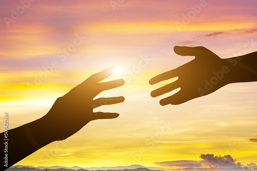 help with sunset background. silhouette of helping hands concept and international day of peace how can i help you