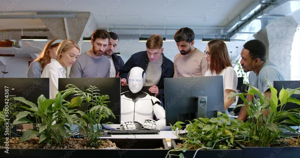 Robot in office, typing on keyboard. People around applauding. Artificial intelligence working at computer in coworking space. IT developers. Humanoid worker. Team cheering up. Artificial intelligence