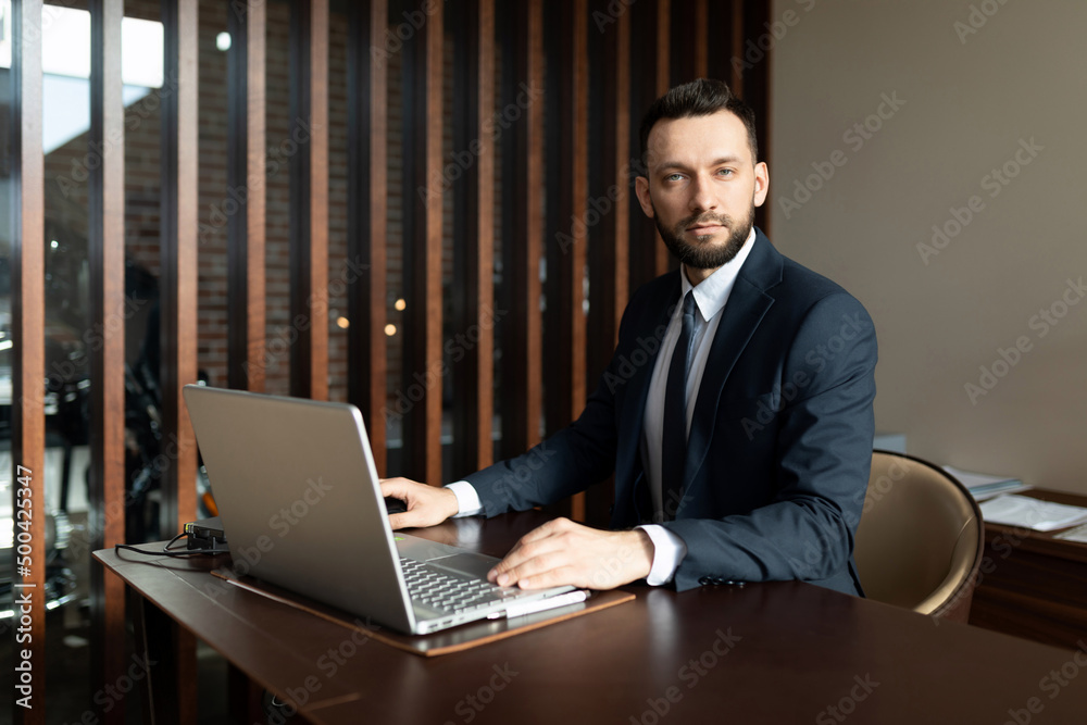 presentable employee of an insurance company in a stylish office at a laptop presentable employee of an insurance company in a stylish office at a laptop