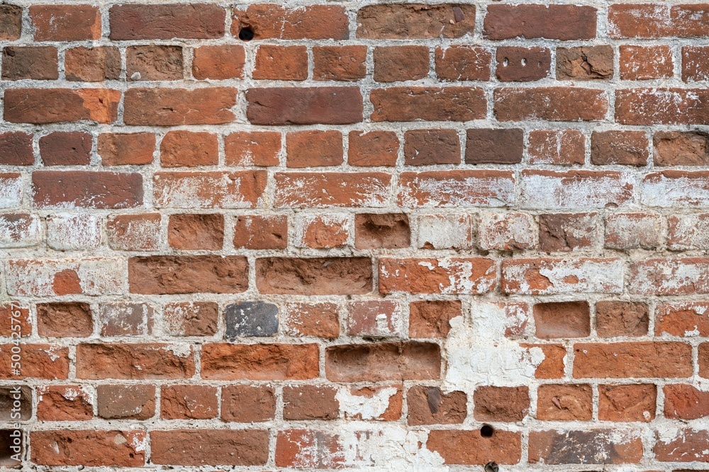 Fototapeta premium Shabby wall of old red brick. Reference material, reference information.