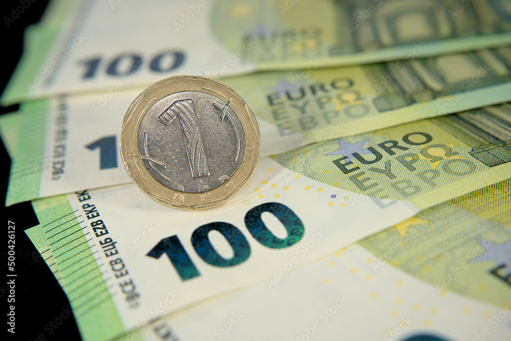 one hundred euro banknotes of the European Union, one Bulgarian lev macro photo one hundred euro banknotes of the European Union, one Bulgarian lev macro photo