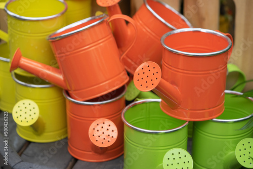 red and green watering cans © Cathy Donohoue