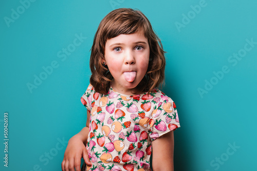 Girl showing tongue in studio photo