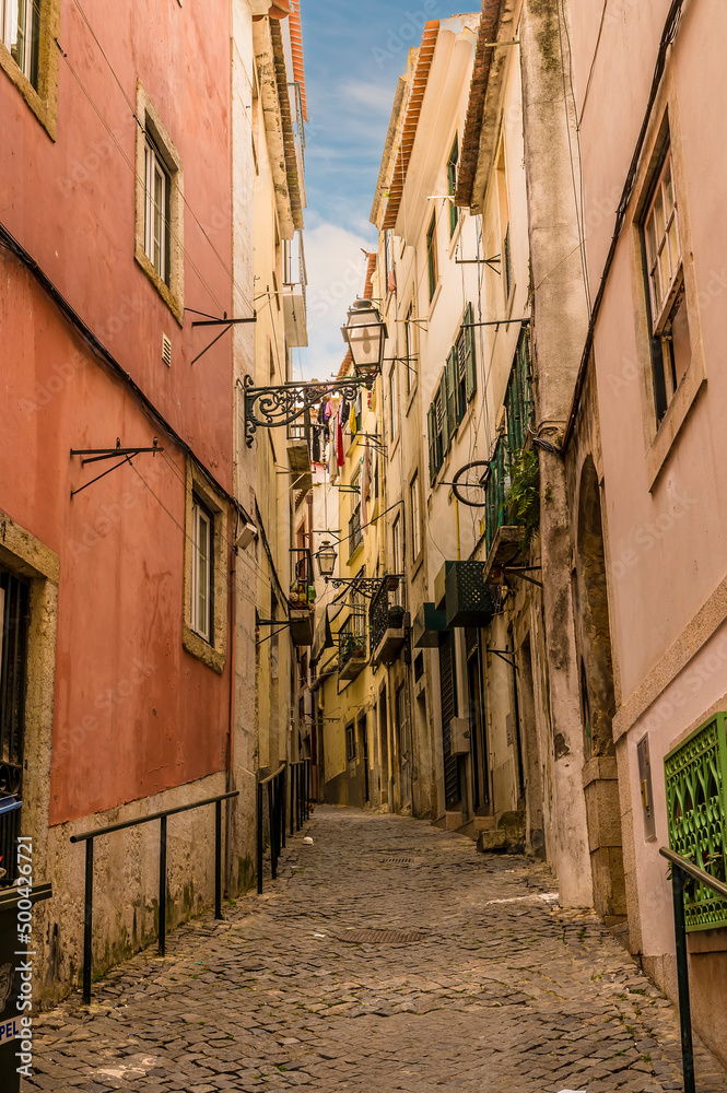 A view up a narrow alley in the Alfama distict in the city of Lisbon on a spring day