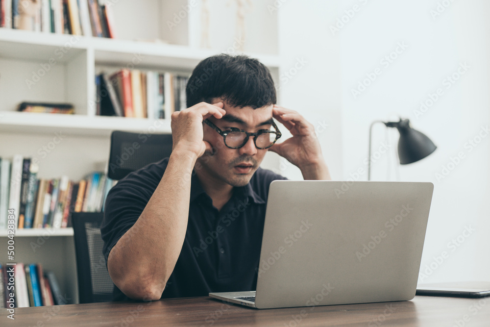 sad depression serious people from work,study stress problem.asian man feeling tired suffering using computer working work place.concept global economic,health problems sad depression serious people from work,study stress problem.asian man feeling tired suffering using computer working work place.concept global economic,health problems