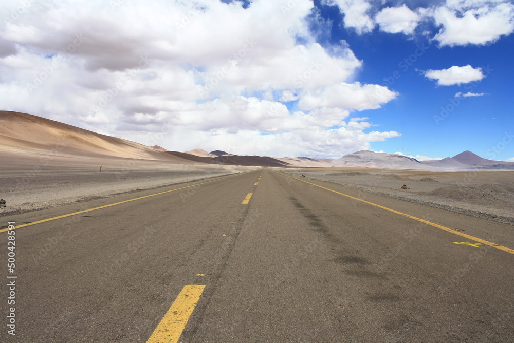Road in Atacama desert savanna, mountains and volcano landscape, Chile, South America
