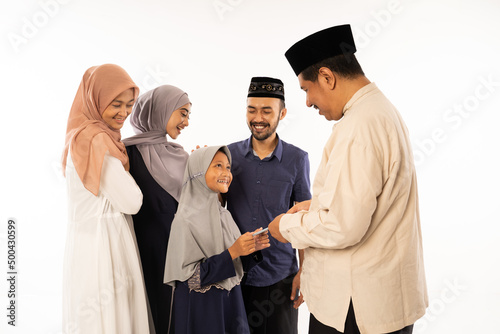 muslim parent giving a suprise gift to their child during idul fitri celebration