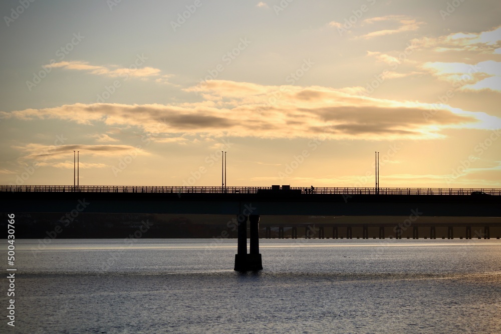 sunset behind bridge