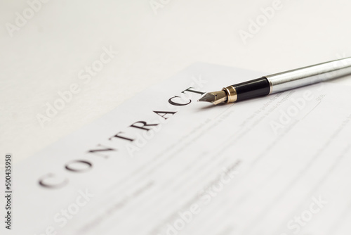 Close-up of a silver ink pen on docunent contract. Legal contract signing