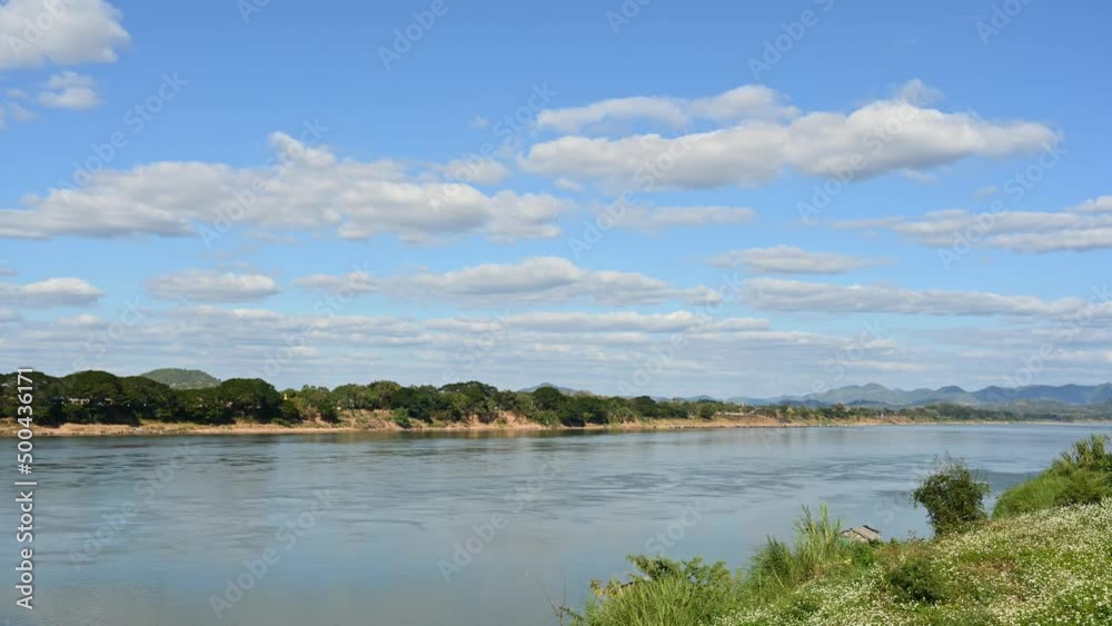 A time lapse of the Mekong River flowing as seen from Thailand side while Laos on the other side while the camera zooms out. A time lapse of the Mekong River flowing as seen from Thailand side while Laos on the other side while the camera zooms out.