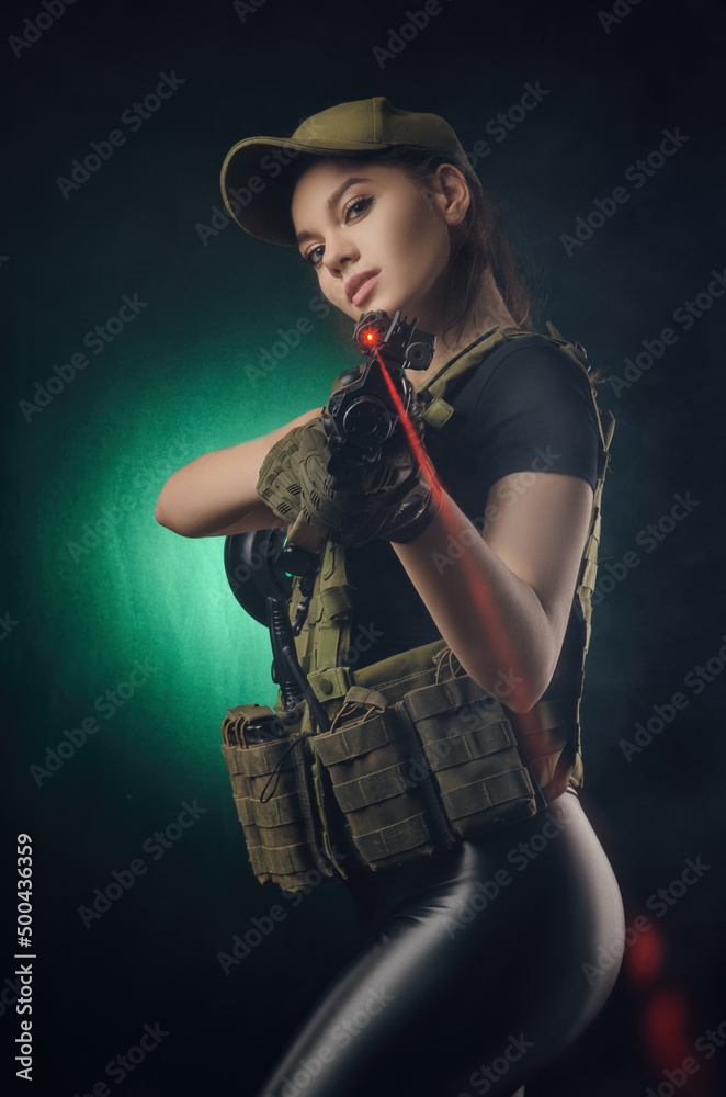 a girl soldier in military clothes with a weapon