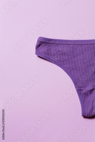 Stylish cotton women's underpants in a scar on a purple background. Creative concept of underwear with space for text. Thong flatlay shorts.