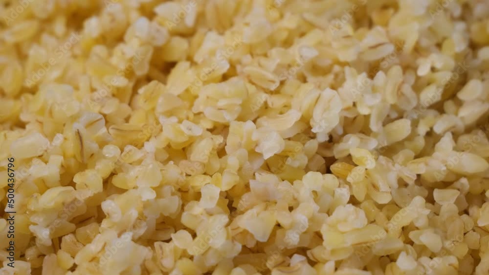 Boiled bulgur grits, close-up. Bulgur porridge, full frame. Shooting of groats. Boiled bulgur grits, close-up. Bulgur porridge, full frame. Shooting of groats.