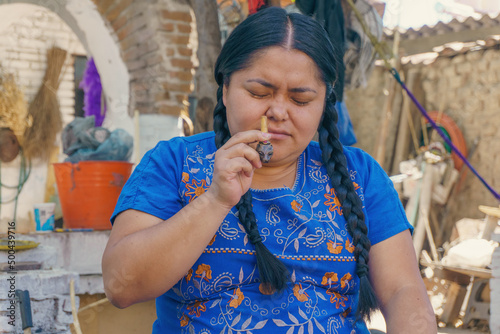 woman applying monkfish ancestral medicine in Mexico photo