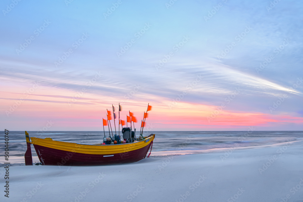 Sunrise in Debki - Poland. Fishing boat against the sea during sunrise 