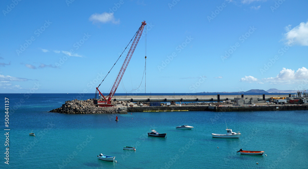 Work in progress on Playa Blanca harbour extension with crane.
