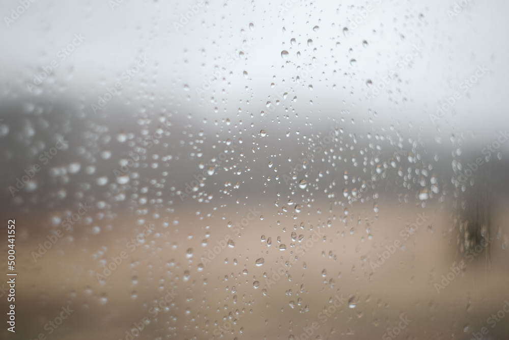 Natural pattern of rain drops on window glass surface.