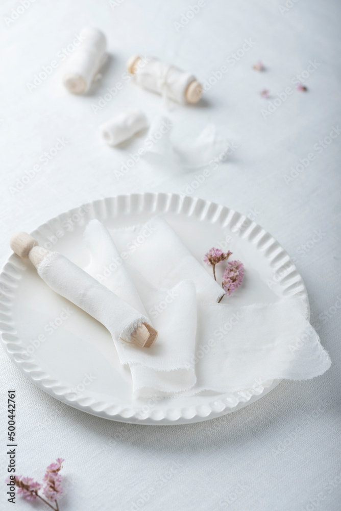 White silk ribbons on the white dish