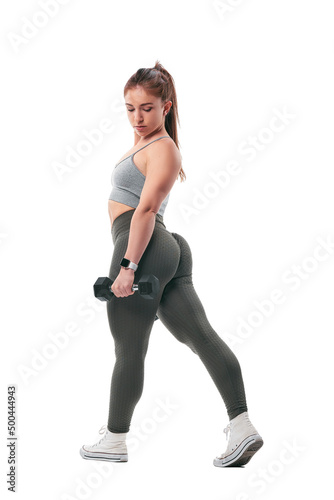 young woman doing sports, using dumbbells, exercising biceps. White studio background.