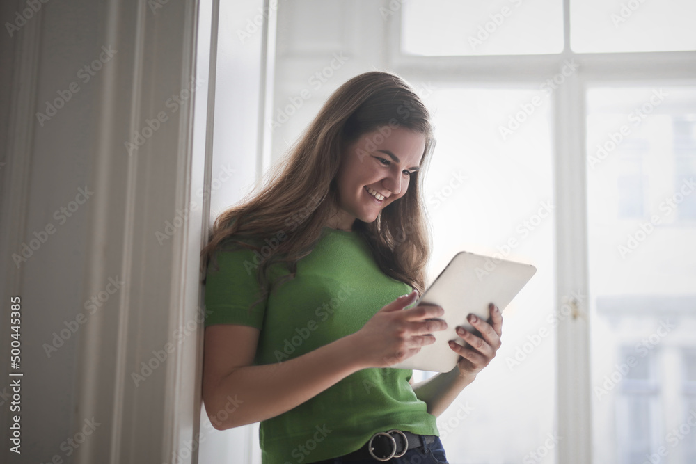 portrait of laughing young woman with tablet portrait of laughing young woman with tablet