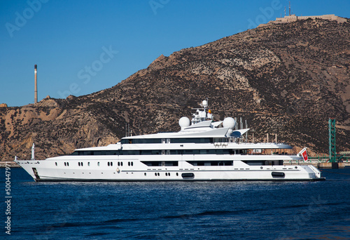 Expensive motor yacht in the ocean on a background of mountains. © Сергей Жмурчак
