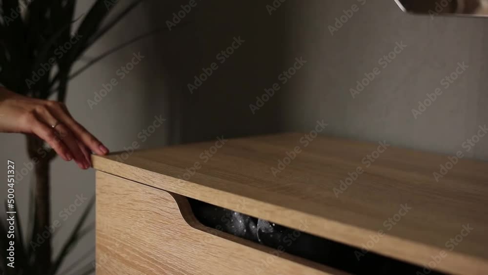 The girl runs her fingers across the table