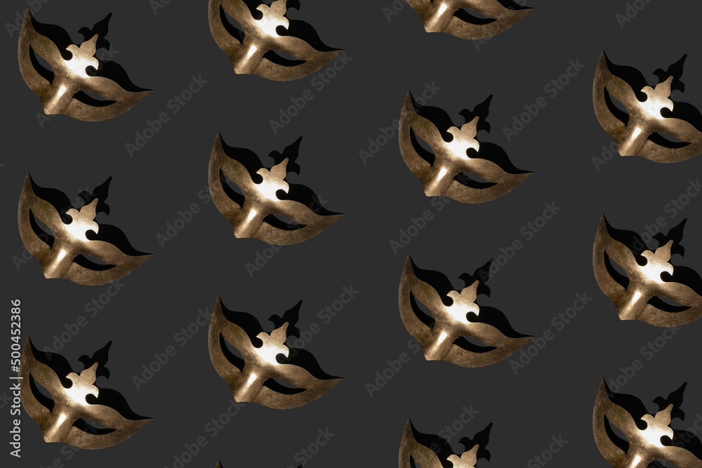 Seamless pattern made of metallic gold masquerade mask on black background. Isometric view. Carnival or Masquerade concept. Seamless pattern made of metallic gold masquerade mask on black background. Isometric view. Carnival or Masquerade concept.