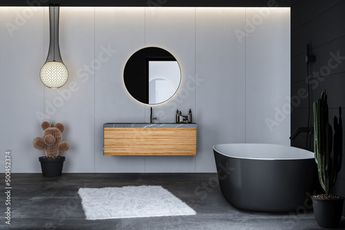 Modern bathroom interior with concrete floor, black bathtub,  and oval mirror, marble basin, pendant light, cactus, front view. Minimalist black bathroom with modern furniture. 3d rendering

