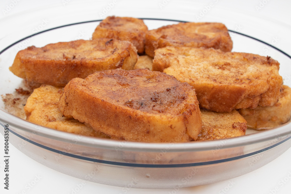 French toast, sweet widely consumed at Easter in Spain, called Torrijas. Isolated on white background. French toast, sweet widely consumed at Easter in Spain, called Torrijas. Isolated on white background.