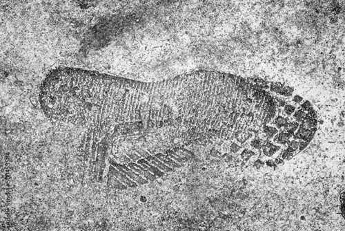 Various raised marks of footprints of different shoes on fresh concrete