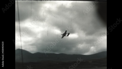Black Widow Banking 1947 - A Northrop P-61 Black Widow Warplane banks left at Adak Airfield in the 1940s photo