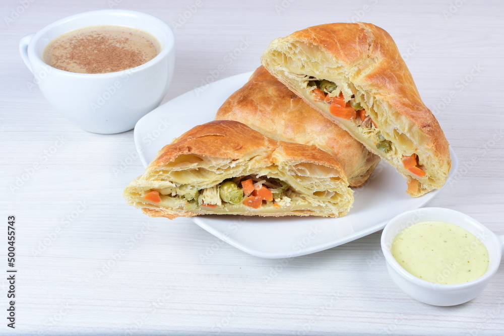 Puff pastry cake with vegetables and cheese, on wooden background Puff pastry cake with vegetables and cheese, on wooden background