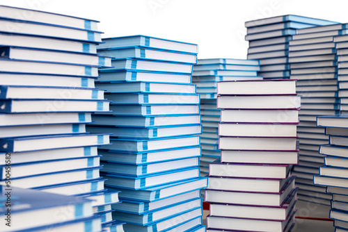 Stacks of books on the table, isolated on a white background.