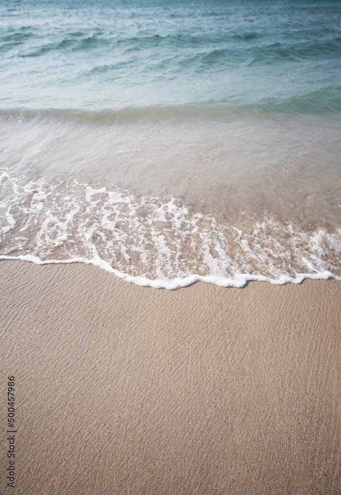 Sand and sea wave. Beach copy space nature background.