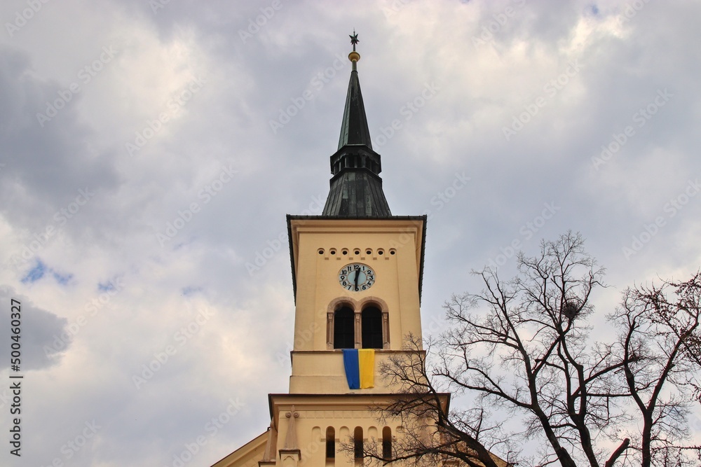A tower of the evangelic church with the flag of Ukraine at Nosislav, Czech republic 