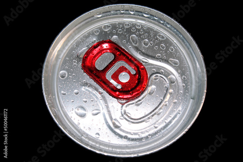 metal soda cap covered with splashes on a black insulated background