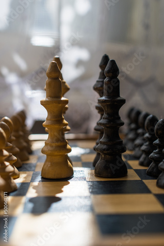 Chess board with figures. The concept of negotiation, the main figures in focus.