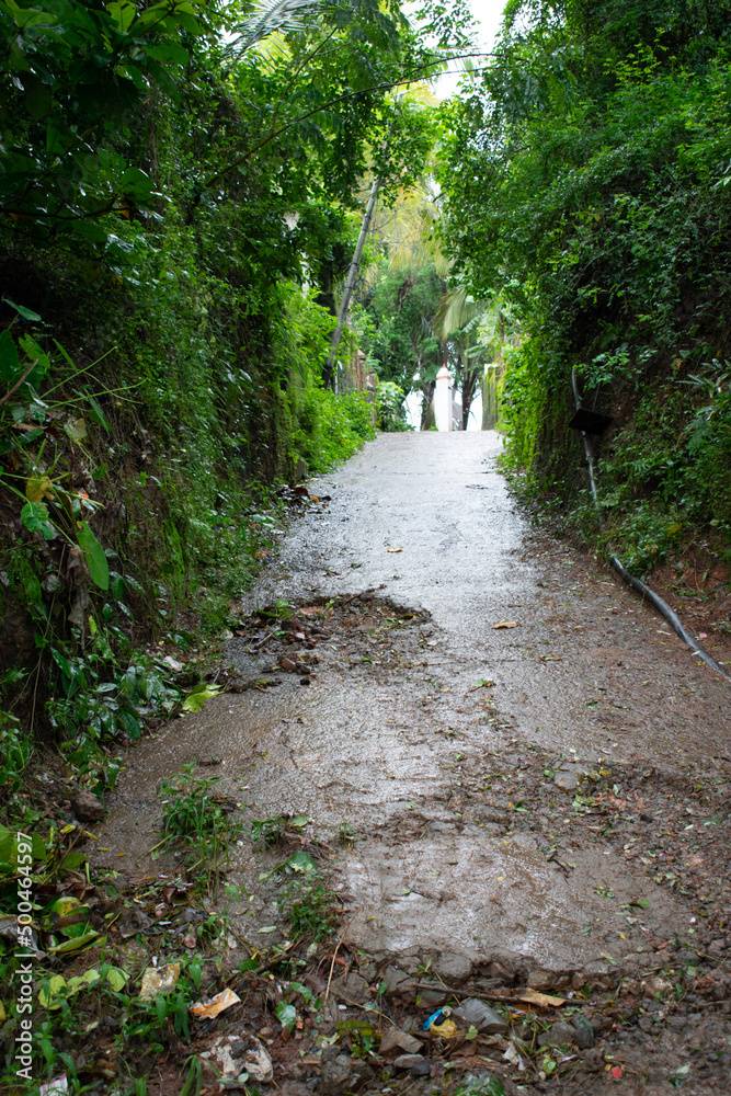 Fototapeta premium Pothole road - damaged rural road surface.