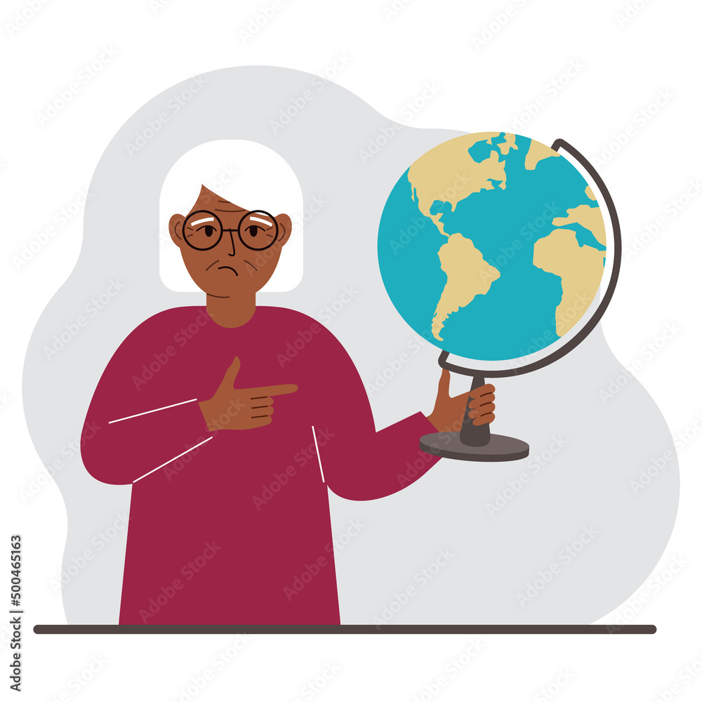 A old woman holds a globe in his hand and points his finger at it. The concept of education, teacher, world conquest, ecology.