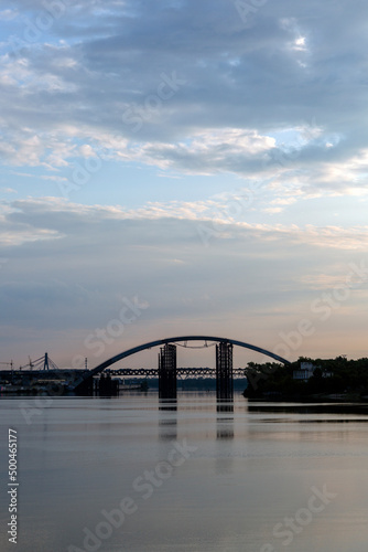 Peaceful sunrise in the sunny morning on the Dnipro river, Kyiv Harbour city, Ukraine. View on the The Podilskyi Bridge © almostfuture