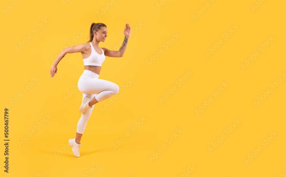 fitness woman runner running on yellow background with copy space