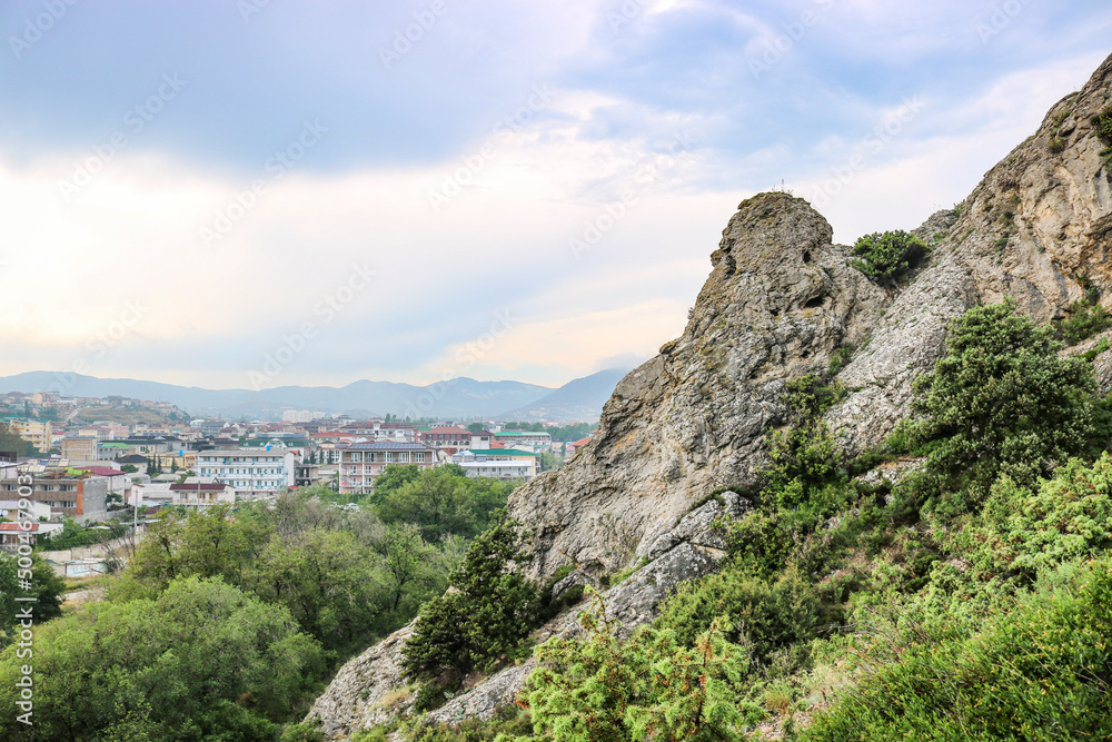 View from the mountains to the town of Sudak, Crimea. Stones close-up, copyspace. View from the mountains to the town of Sudak, Crimea. Stones close-up, copyspace.