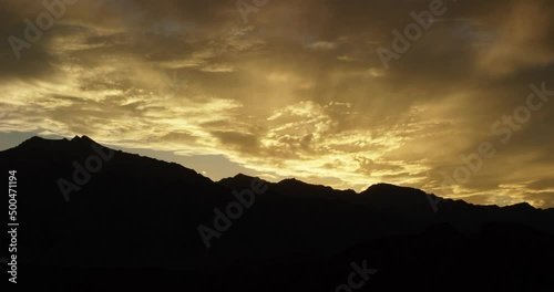 Bright and saturated sunset sky over mountains in Alabama Hills, California 