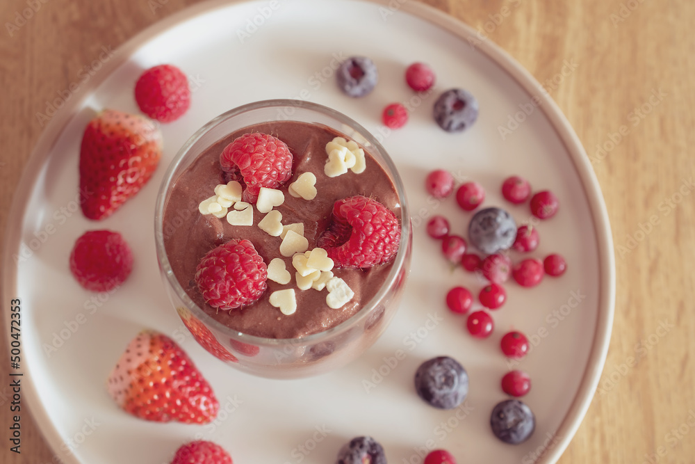 Chocolate mousse with raspberries and strawberries in a glass Chocolate mousse with raspberries and strawberries in a glass