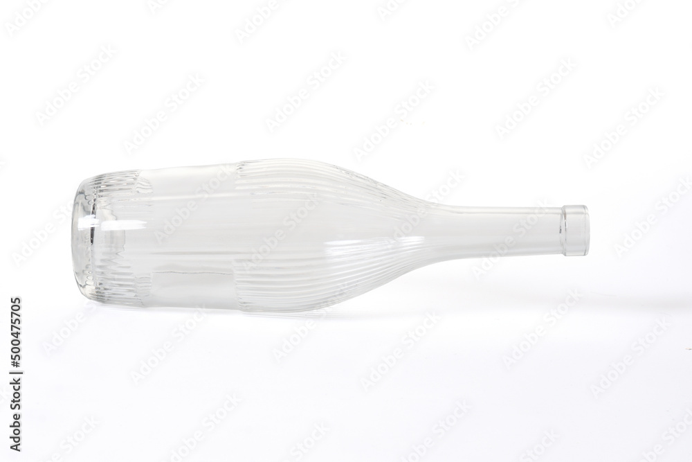 lying down of glass bottle with textured vertical stipes isolated on white background lying down of glass bottle with textured vertical stipes isolated on white background