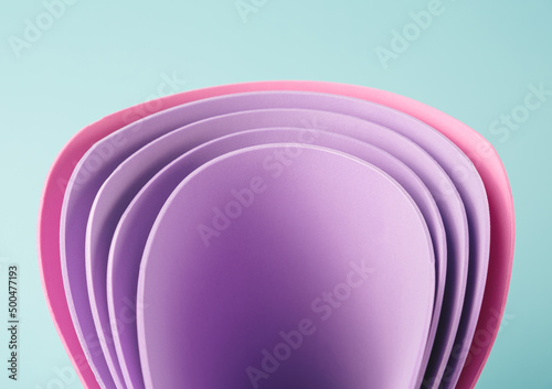 Perwinkle and pink curved sheets on a minty background. Abstract business backdrop photo