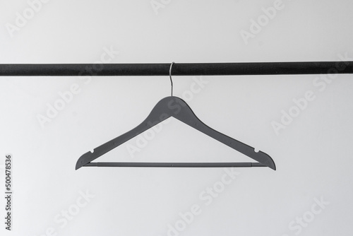 simple single clothes hanger on the rack, abstract simple fashion concept photo